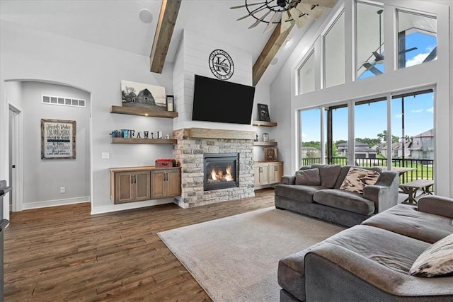 1013 Old Hickory Rd, Greenwood, MO 64034 - living area featuring high vaulted ceiling, a fireplace, dark wood-type flooring, beamed ceiling, and a ceiling fan