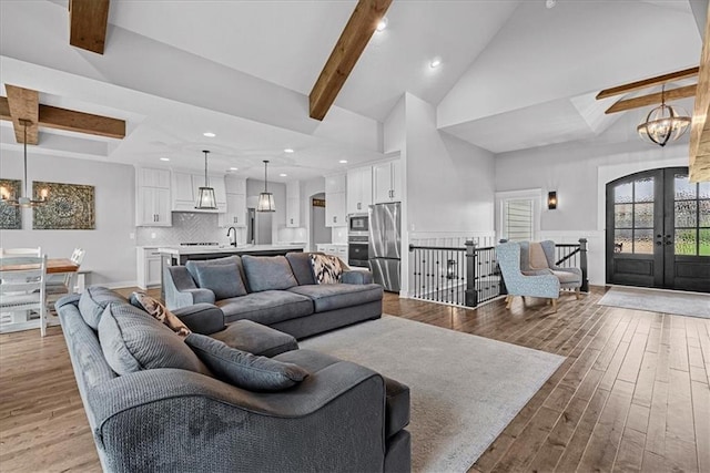 1013 Old Hickory Rd, Greenwood, MO 64034 - living room featuring french doors, a chandelier, wood finished floors, recessed lighting, and high vaulted ceiling