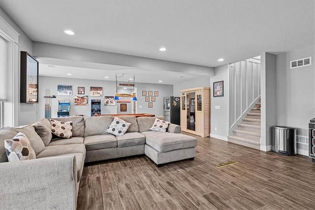 1013 Old Hickory Rd, Greenwood, MO 64034 - living room featuring a bar, stairway, wood finished floors, recessed lighting, and a textured ceiling
