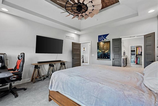 1013 Old Hickory Rd, Greenwood, MO 64034 - carpeted bedroom with a raised ceiling, recessed lighting, an office area, ceiling fan, and a walk in closet