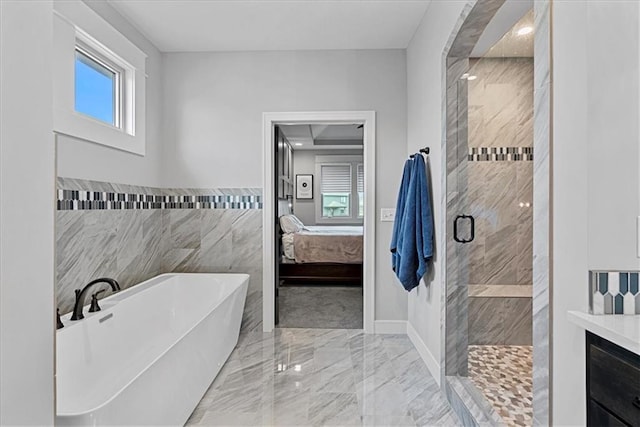 1013 Old Hickory Rd, Greenwood, MO 64034 - full bath with a soaking tub, marble tiled floors, a stall shower, ensuite bath, and tile walls