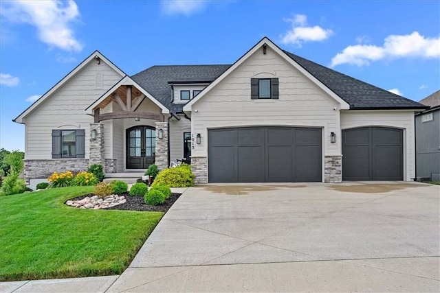 1013 Old Hickory Rd, Greenwood, MO 64034 - view of front of home with stone siding, a front lawn, concrete driveway, an attached garage, and roof with shingles