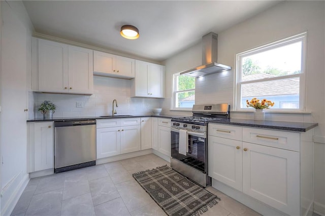 29 S 26th St, Kansas City, KS 66102 - kitchen featuring stainless steel appliances, ventilation hood, backsplash, white cabinets, and light tile patterned floors