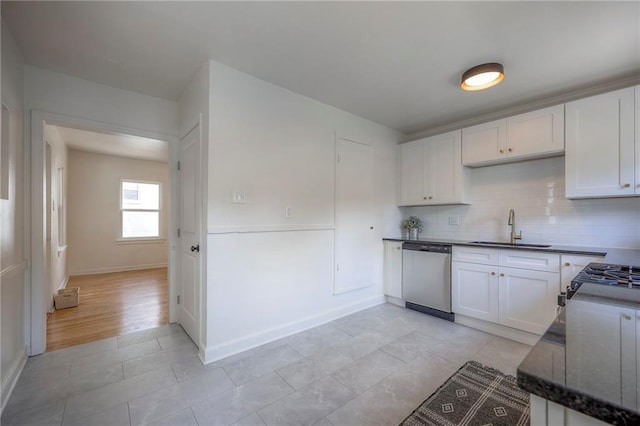29 S 26th St, Kansas City, KS 66102 - kitchen featuring stainless steel dishwasher, white cabinetry, and backsplash