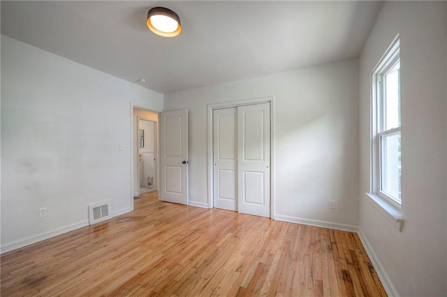29 S 26th St, Kansas City, KS 66102 - unfurnished bedroom with light wood-style floors and a closet