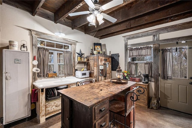 15335 Hh Hwy, Platte City, MO 64079 - kitchen featuring wooden counters, white microwave, ceiling fan, a kitchen island, and a wooden ceiling with exposed beams