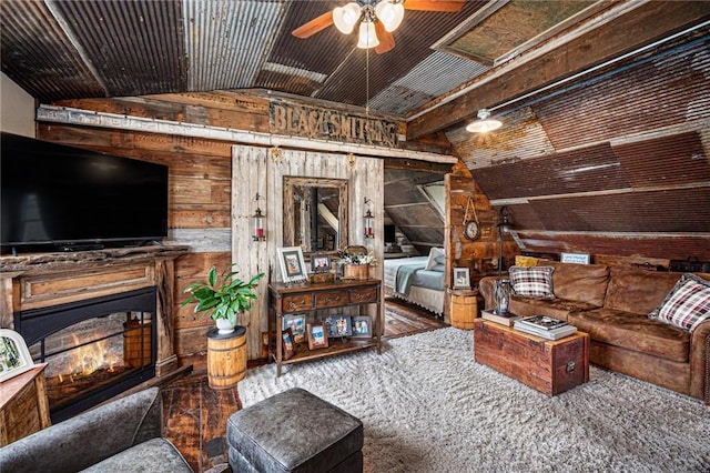 15335 Hh Hwy, Platte City, MO 64079 - living area with lofted ceiling, wood walls, ceiling fan, and a glass covered fireplace