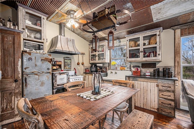 15335 Hh Hwy, Platte City, MO 64079 - kitchen with stainless steel microwave, exhaust hood, a ceiling fan, freestanding refrigerator, and dark wood finished floors
