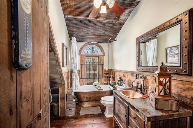 15335 Hh Hwy, Platte City, MO 64079 - bathroom with a freestanding tub, vanity, wainscoting, ceiling fan, and lofted ceiling