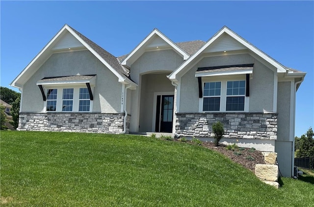 11494 S Longview Rd, Olathe, KS 66061 - view of front facade featuring stone siding, a front yard, and stucco siding