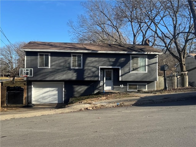 1012 S 10th St, Atchison, KS 66002 - bi-level home featuring a garage and roof with shingles