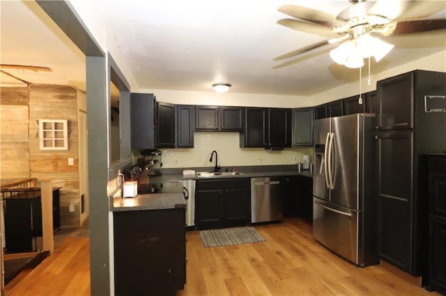 1012 S 10th St, Atchison, KS 66002 - kitchen with appliances with stainless steel finishes, dark countertops, ceiling fan, dark cabinets, and wooden walls