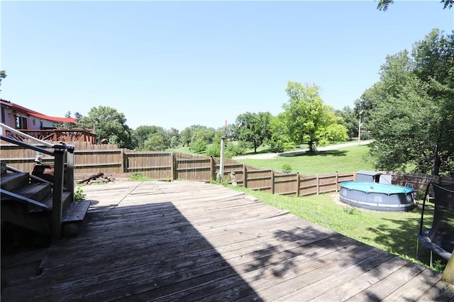 1012 S 10th St, Atchison, KS 66002 - wooden deck featuring a fenced backyard and a trampoline