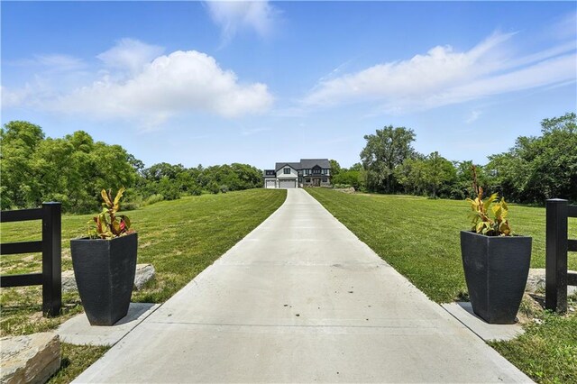 8422 NE 147th St, Liberty, MO 64068 - view of home's community with concrete driveway and a yard