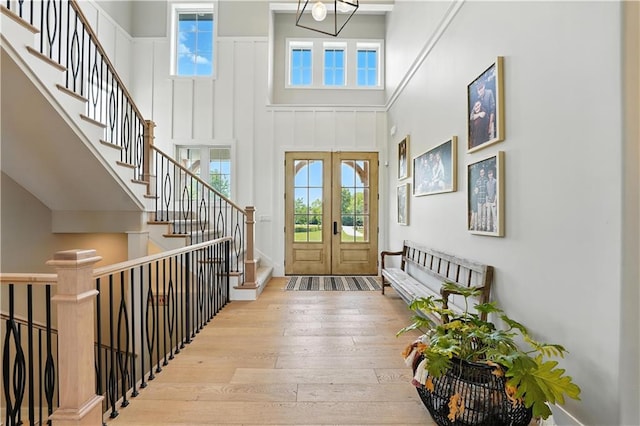 8422 NE 147th St, Liberty, MO 64068 - foyer with wood-type flooring, a high ceiling, stairway, and french doors
