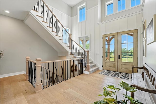 8422 NE 147th St, Liberty, MO 64068 - foyer entrance featuring hardwood / wood-style flooring, a high ceiling, french doors, stairway, and recessed lighting