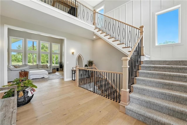 8422 NE 147th St, Liberty, MO 64068 - staircase with plenty of natural light, wood finished floors, and a towering ceiling