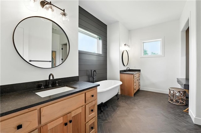 8422 NE 147th St, Liberty, MO 64068 - bathroom featuring plenty of natural light, two vanities, and a freestanding tub