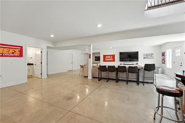 8422 NE 147th St, Liberty, MO 64068 - living area featuring concrete flooring, recessed lighting, and bar