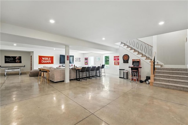 8422 NE 147th St, Liberty, MO 64068 - living room featuring concrete floors, stairs, recessed lighting, and bar area