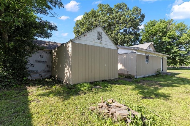 715 Walnut Ave, Osawatomie, KS 66064 - view of property exterior featuring a storage shed and a lawn
