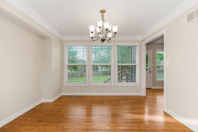 1129 SW Georgetown Dr, Lees Summit, MO 64082 - unfurnished dining area with a chandelier, light wood finished floors, and crown molding