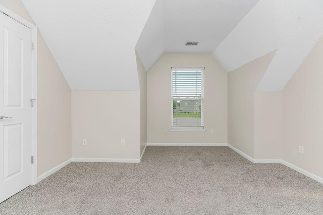 1129 SW Georgetown Dr, Lees Summit, MO 64082 - additional living space featuring vaulted ceiling and carpet