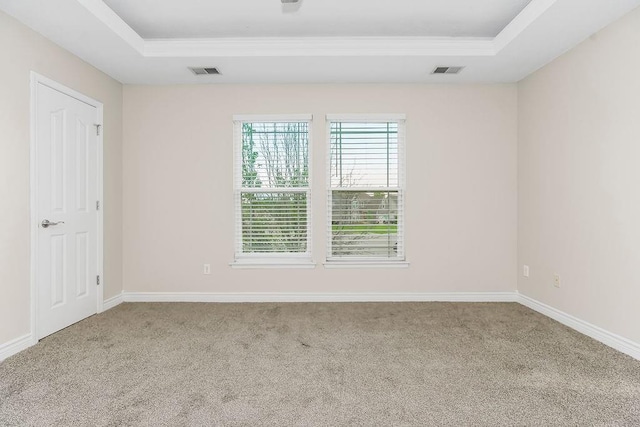 1129 SW Georgetown Dr, Lees Summit, MO 64082 - carpeted empty room featuring a tray ceiling and ornamental molding
