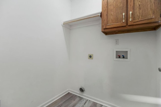 1129 SW Georgetown Dr, Lees Summit, MO 64082 - laundry area with washer hookup, cabinet space, electric dryer hookup, and wood finished floors