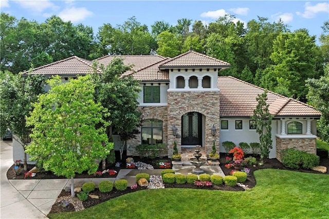 11110 W 146th Ter, Overland Park, KS 66221 - mediterranean / spanish-style house with a tiled roof, stone siding, a front yard, and stucco siding