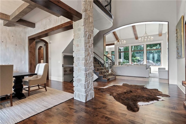 11110 W 146th Ter, Overland Park, KS 66221 - foyer featuring beamed ceiling, arched walkways, wood finished floors, a chandelier, and stairs