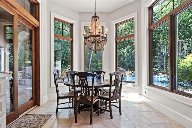 11110 W 146th Ter, Overland Park, KS 66221 - dining room featuring stone tile floors and a chandelier