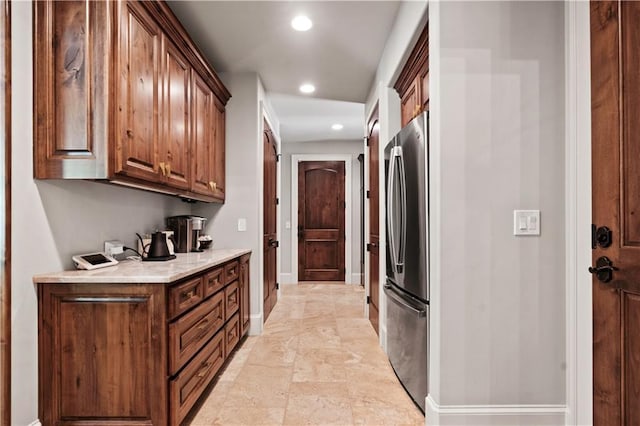 11110 W 146th Ter, Overland Park, KS 66221 - kitchen featuring freestanding refrigerator, recessed lighting, light countertops, and brown cabinetry