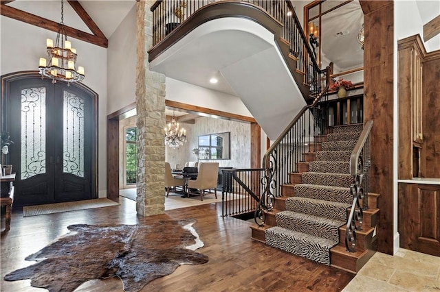 11110 W 146th Ter, Overland Park, KS 66221 - entryway with french doors, high vaulted ceiling, arched walkways, a chandelier, and ornate columns