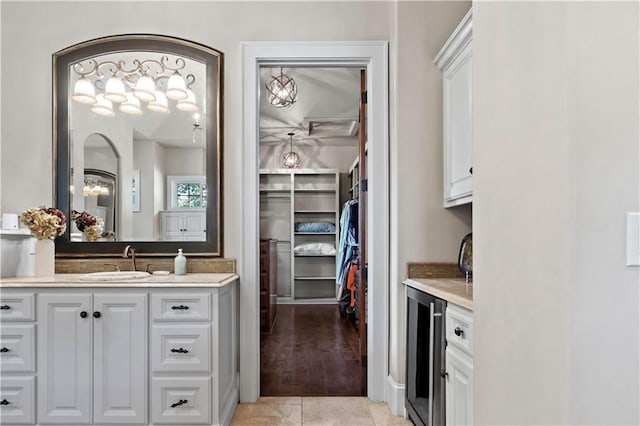 11110 W 146th Ter, Overland Park, KS 66221 - full bath featuring beverage cooler, vanity, a spacious closet, and tile patterned flooring