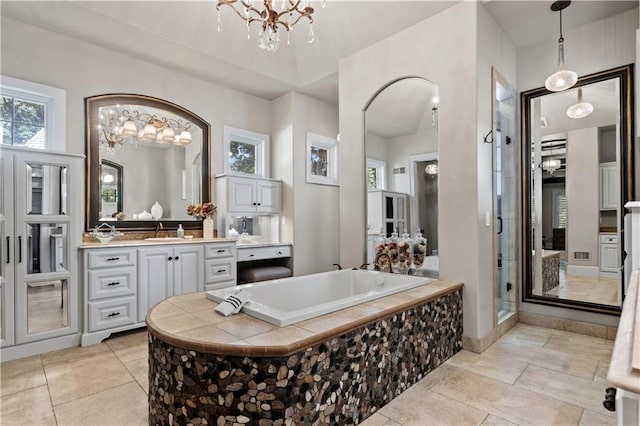 11110 W 146th Ter, Overland Park, KS 66221 - bathroom with a chandelier, a bath, vanity, and a stall shower