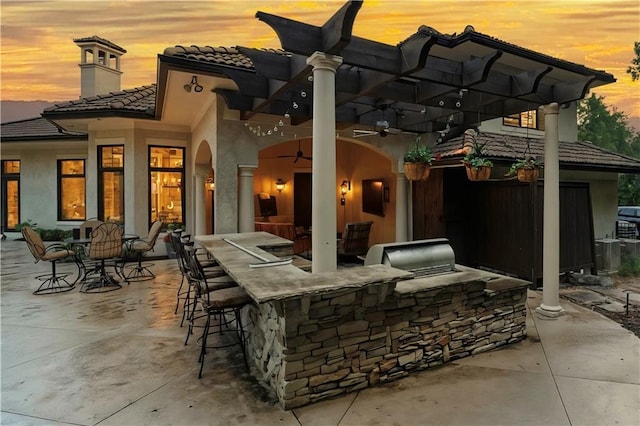 11110 W 146th Ter, Overland Park, KS 66221 - view of patio with an outdoor kitchen and a ceiling fan