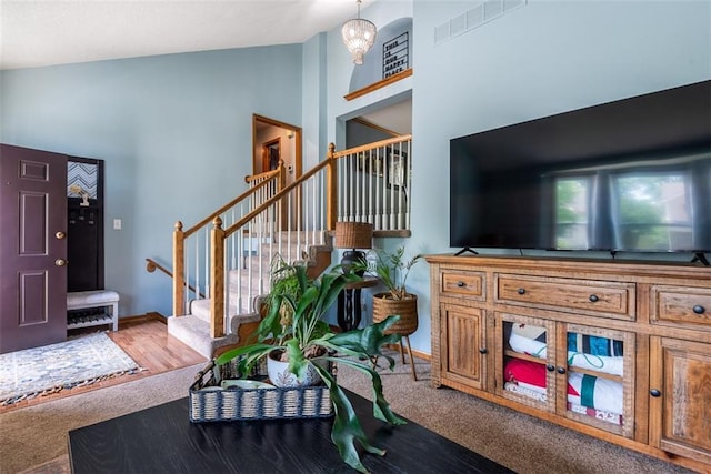 190 W Colleen Ct, Gardner, KS 66030 - carpeted living room featuring stairway and high vaulted ceiling