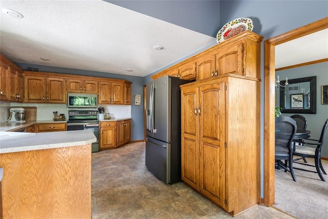 190 W Colleen Ct, Gardner, KS 66030 - kitchen with stainless steel appliances, light countertops, brown cabinetry, and a textured ceiling