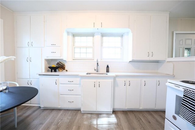 1034 E Lexington Ave, Independence, MO 64050 - kitchen with light wood-style flooring, white electric stove, and light countertops
