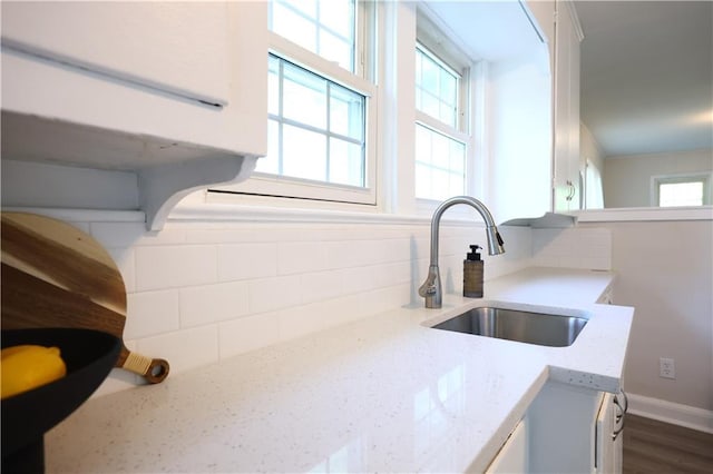 1034 E Lexington Ave, Independence, MO 64050 - kitchen featuring backsplash, plenty of natural light, and light stone counters