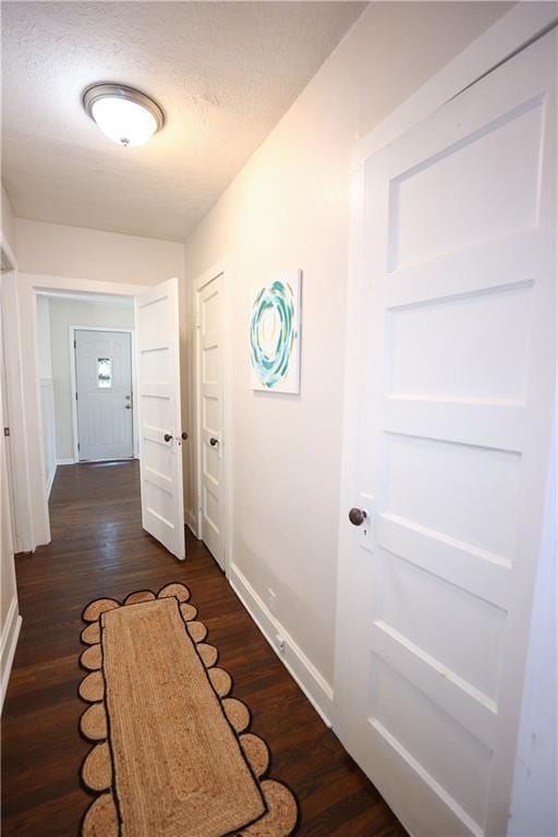 1034 E Lexington Ave, Independence, MO 64050 - hallway with dark wood-style flooring and a textured ceiling