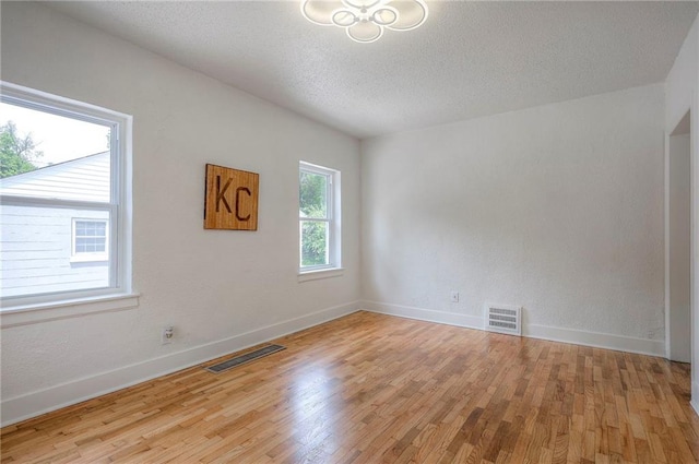 41 S 26th St, Kansas City, KS 66102 - empty room featuring light wood-style flooring and a textured ceiling