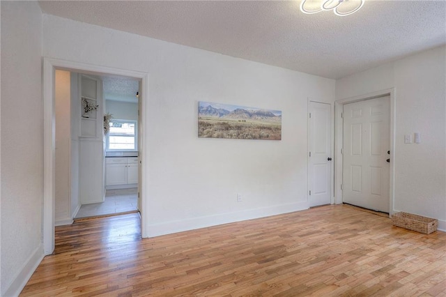 41 S 26th St, Kansas City, KS 66102 - unfurnished room with light wood finished floors and a textured ceiling