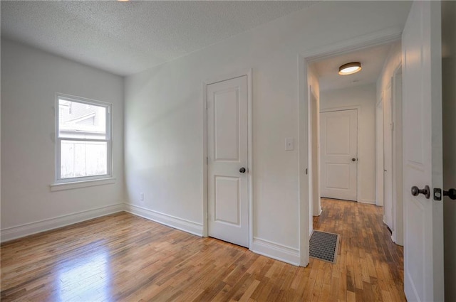 41 S 26th St, Kansas City, KS 66102 - unfurnished room featuring light wood-style flooring and a textured ceiling