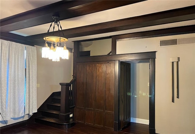233 Main St, Osawatomie, KS 66064 - unfurnished dining area featuring dark wood-type flooring, stairs, beamed ceiling, and a chandelier