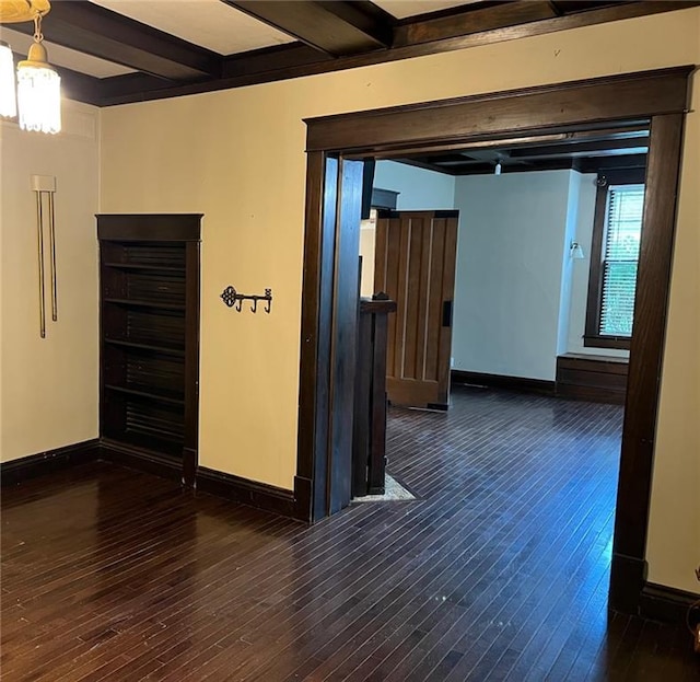 233 Main St, Osawatomie, KS 66064 - spare room featuring beamed ceiling, dark wood-type flooring, and a chandelier