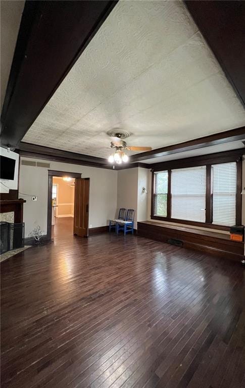 233 Main St, Osawatomie, KS 66064 - unfurnished living room featuring a ceiling fan, a fireplace, and hardwood / wood-style floors