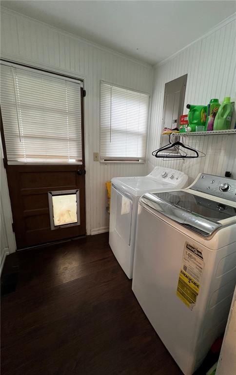 233 Main St, Osawatomie, KS 66064 - laundry room featuring washing machine and dryer, dark wood-style flooring, crown molding, and electric panel