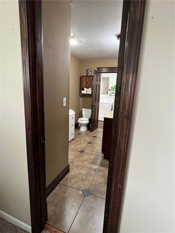 233 Main St, Osawatomie, KS 66064 - bathroom with vanity, washer / dryer, and tile patterned floors